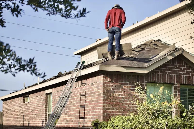 Professional roofer working on a residential roof in South Weymouth